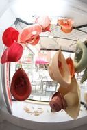 colorful hats hanging in a shop window