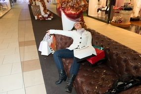 girl with purchases resting on the sofa