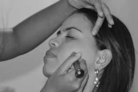 applying makeup on a woman's face