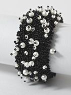 black and white bracelet on her arm