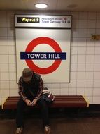 man on a bench in the London Underground