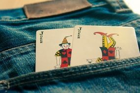 joker cards in a pocket of blue jeans