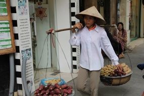 woman wearing shopping cart street seller