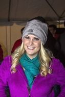 girl in a purple jacket and a gray hat