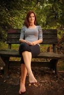 beautiful barefoot girl on a park bench