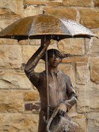 bronze statue with an umbrella