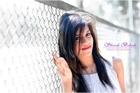 model posing near the fence