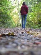 Walking girl in autumn forest