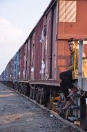 attractive young boy sits on steps at cargo wagon