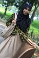 stylish muslim girl with bag outdoor