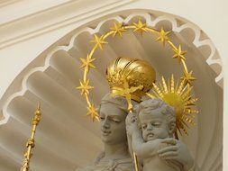 statue of a woman with a child in a halo of gold