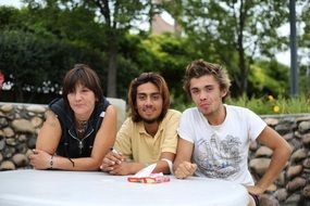 Smiling people sit near table