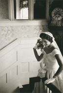 vintage photo Jacqueline Kennedy in a wedding dress on the stairs in 1953