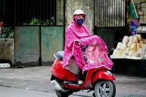 woman in rain coat in vietnam