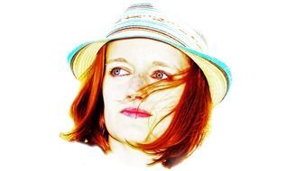 red haired woman in panama hat