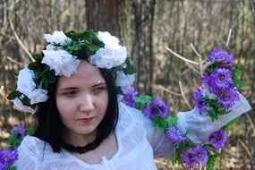Portrait of girl model with flowers on a her head