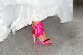 bride in a bright pink shoe
