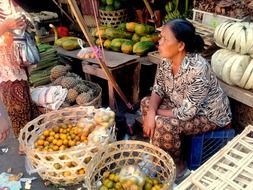 adult woman sells fruits on market, indonesia, bali