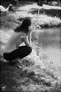 black and white photo of a girl near the lake