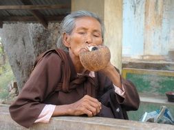 elderly woman smokes marijuana