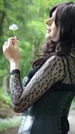 portrait of the happy woman with dandelion in the hands