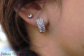 diamond earrings in the female ear