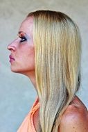 profile portrait of a blonde with bright makeup