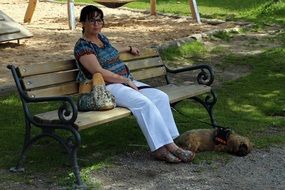 woman resting on a bench in a park