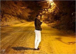 Standing girl on a night road