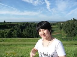 landscape of chinese woman on a green field