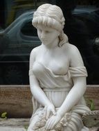 statue of a woman on a city street