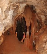 girl archiologist in a dark cave