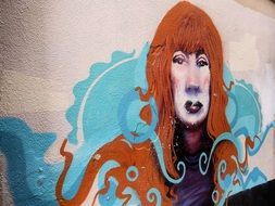 graffiti in the form of a red-haired woman