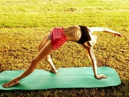 girl in a yoga pose on nature