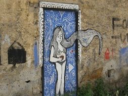 long haired woman with red apple, painting on wall