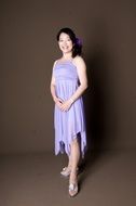 smiling brunette in purple dress