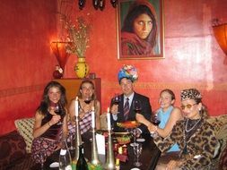 company in oriental costumes in a restaurant to celebrate