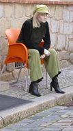 mannequin on an orange chair as a city sculpture