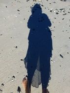 women's shadow on the beach