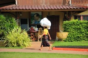 woman bearing laundry on the head outdoor