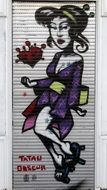 colorful graffiti of asian woman on a wall in berlin