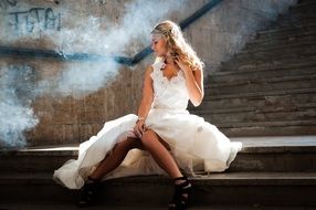 Model woman is sitting on the stairs