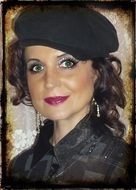 woman in a black cap with curly hair