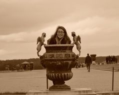 woman near a vase in Versailles