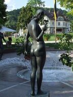bronze statue of a woman near the fountain