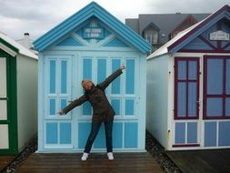 woman with open arms on the background of colorful houses