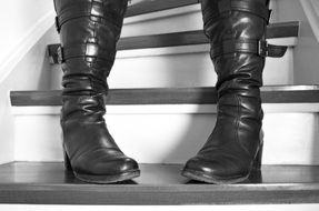 Black woman's boots are on the stairs