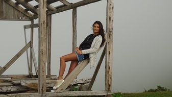 girl posing on wooden beams