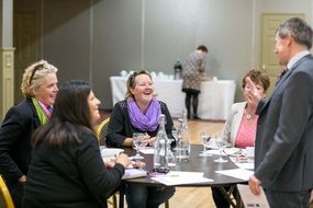 happy mature people at table in office
