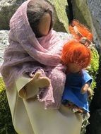 stone woman with a doll